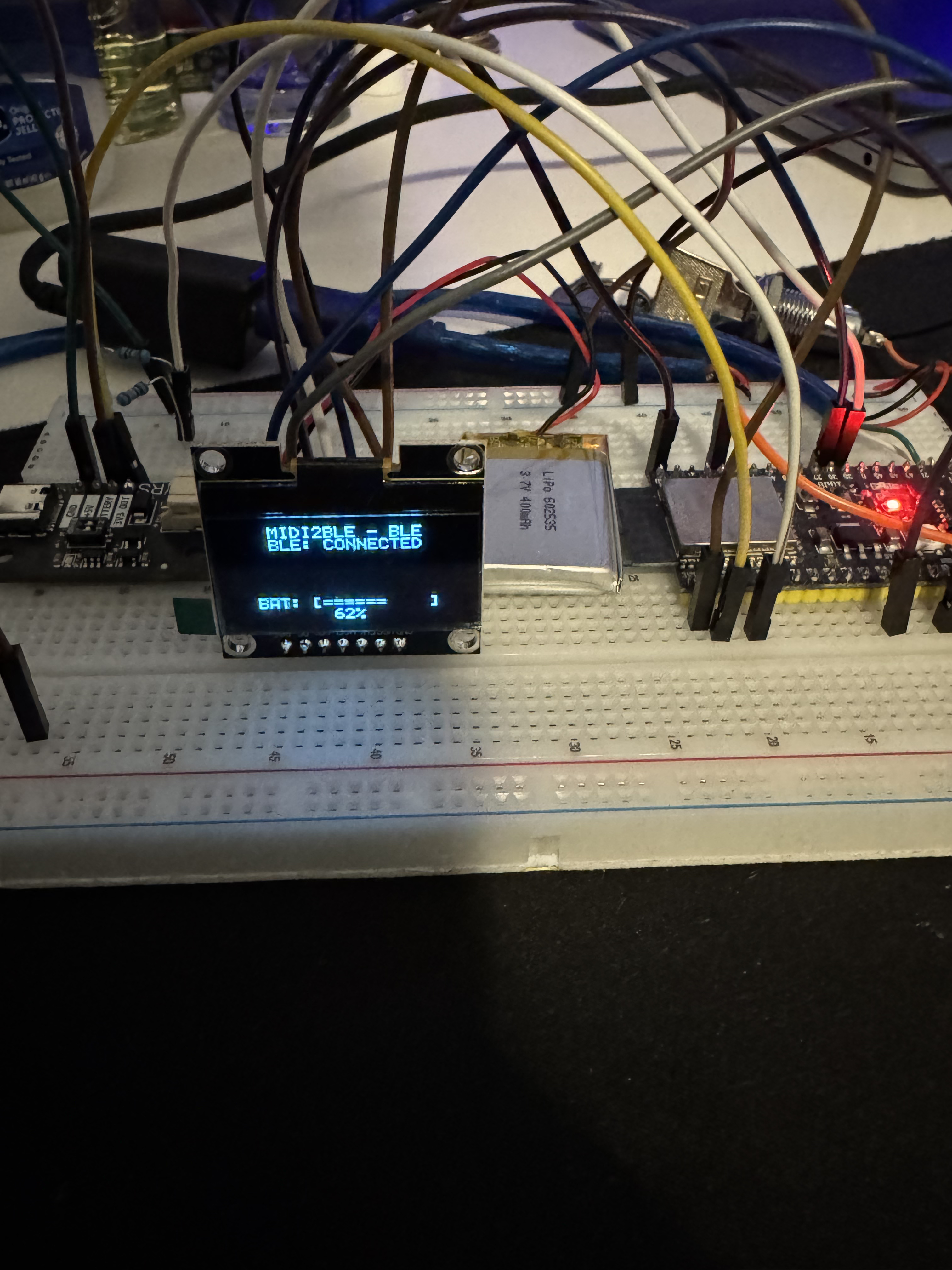 Breadboard prototype with OLED display showing MIDI2BLE BLE CONNECTED